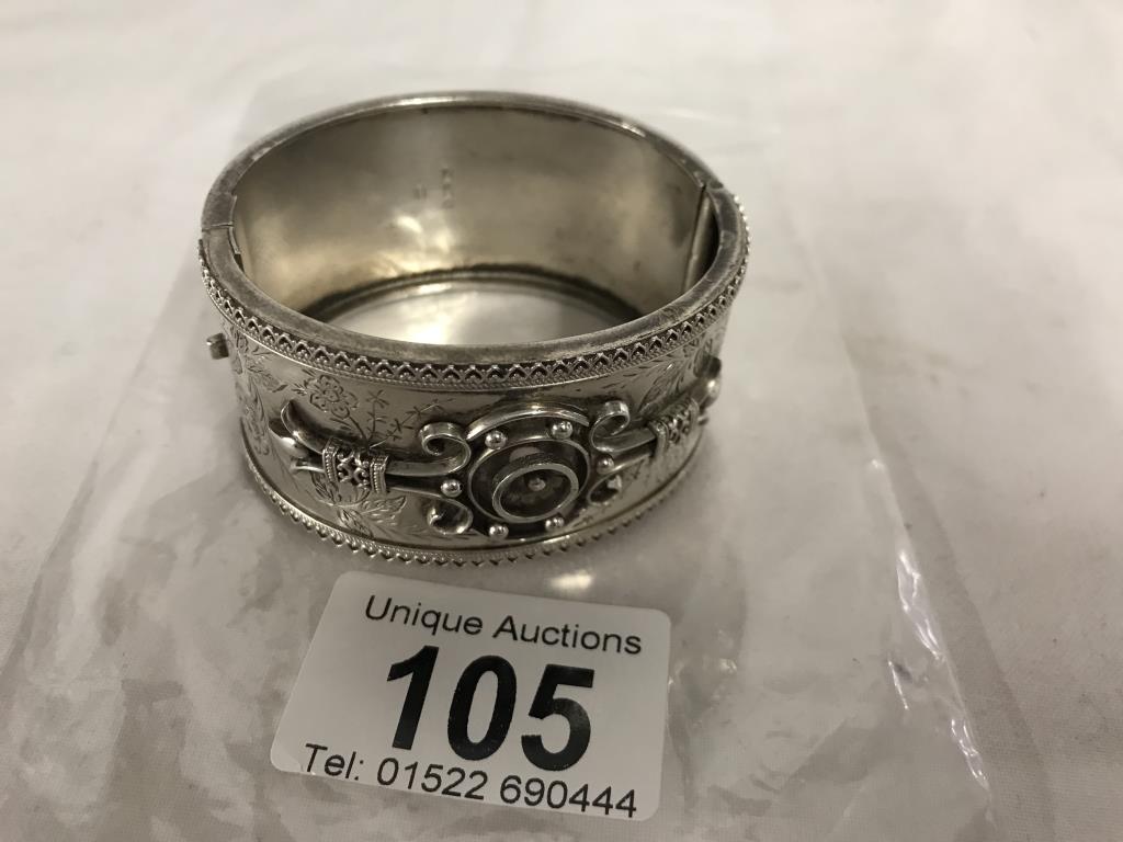 A decorative silver bangle, 37.9 grams. 32mm wide. 43mm x 47mm inside. Outer circumference