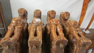 A set of four carved wood lion/griffin furniture supports. Collect only.