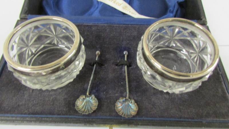 A cased pair of silver rimmed salts with spoons, a silver lidded pill box and a silver mustard - Image 2 of 3