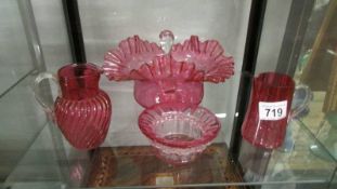 A large cranberry glass bowl, a smaller bowl and two jugs. Collect only.