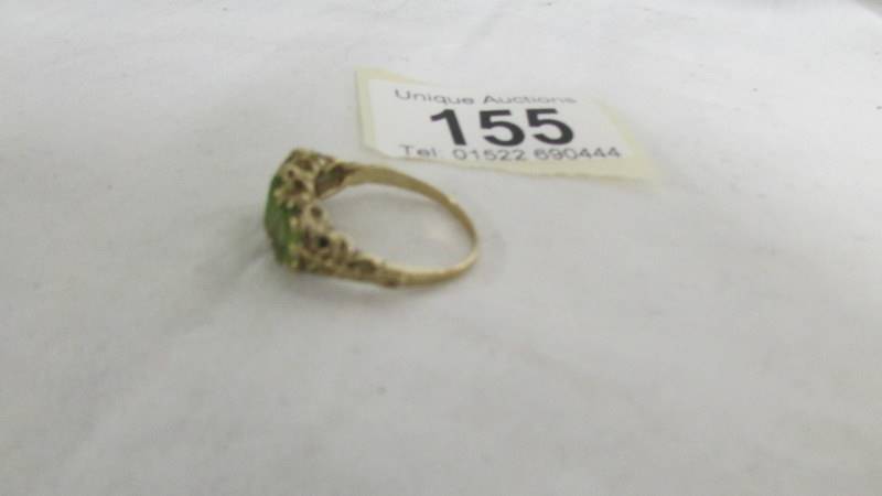 A ring set three large peridot, size R. (tests as gold). - Image 2 of 2