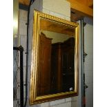 A bevel edged gilt framed mirror, 69 x 100 cm.