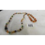 A mixed agate necklace and an orange stone set bracelet.