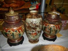 A pair of Satsuma lidded vases and another vase. (Collect only).