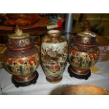 A pair of Satsuma lidded vases and another vase. (Collect only).