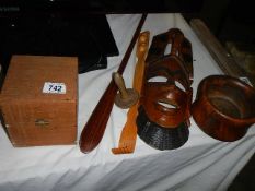 A wooden wall mask and other wooden items.