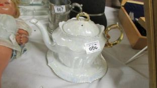 A pretty lustre teapot on stand.