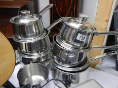 A set of stainless steel saucepans. (Collect only).