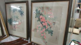 A pair of framed and glazed signed oriental floral studies. (Collect only).