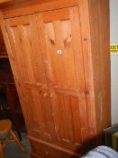 A pine double door wardrobe with single drawer. (Collect only).