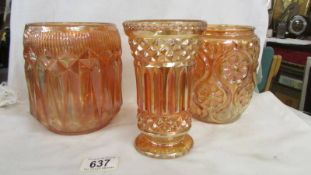 Two carnival glass marigold biscuit barrels (missing lids) and a vase.