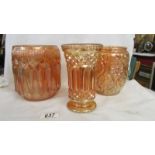 Two carnival glass marigold biscuit barrels (missing lids) and a vase.