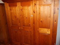 A triple door pine wardrobe. (Collect only).