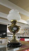 A brass oil lamp with later shade. (Collect only).