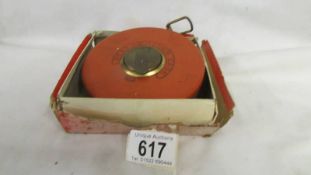 A boxed BMI all leather case tape measure.