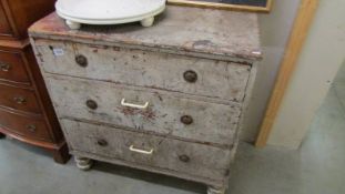 An old three drawer chest.