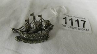 A silver marcasite brooch of a Viking ship.