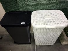 A white plastic linen basket & a plastic pedal kitchen bin