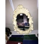 An ornate resin framed mirror (40cm x 60cm) (COLLECT ONLY)