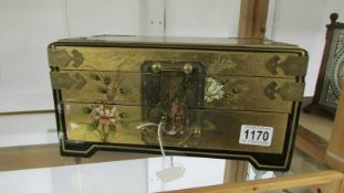 A Japanese lacquered jewellery box with brass fittings.