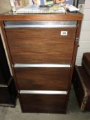 A wood effect three drawer filing cabinet, (Collect only).