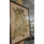 An unusual framed and glazed map of New Zealand on a possum skin.