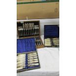 Three cased sets of fish knives and forks.