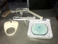 An adjustable illuminated magnifier & 1 other (no stands)