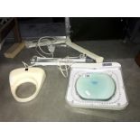 An adjustable illuminated magnifier & 1 other (no stands)