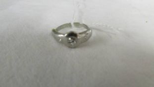 A white metal ring, size N,