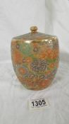 A 6" high Japanese ceramic biscuit jar with lid. Lovely heavily patterned body.