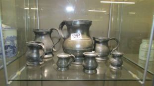 A set of seven antique pewter measures by James Yeates.