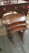 A nest of three mahogany tables.