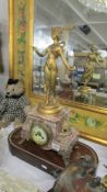 An early French marble and ormolu mantel clock surmounted figure. in working order.