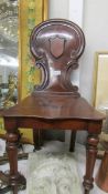 A Victorian mahogany hall chair.