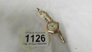 An art deco 9ct gold cased Majex ladies wrist watch on 9ct gold strap, in working order.