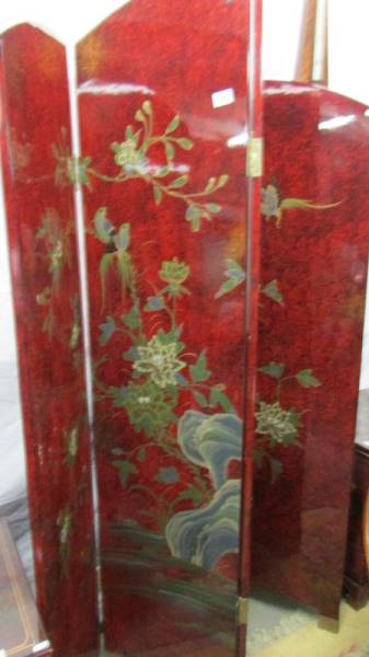 A lacquered four fold screen.