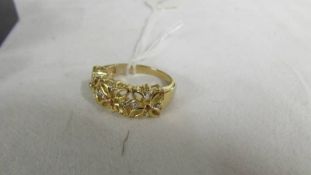 A yellow metal floral ring, size R half.