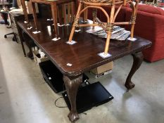 A late 19th century extending dining table with one leaf.