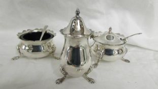 A three piece hall marked condiment set with blue plastic liners, silver weight 130 grams.
