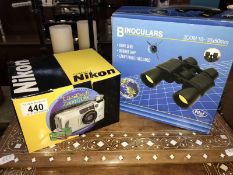 A boxed set of binoculars & a boxed Nikon compact camera