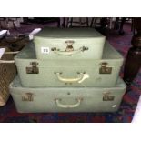 A set of 3 vintage graduated suitcases