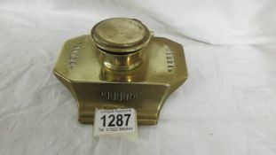 A brass inkwell (missing liner).