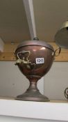 A copper samovar with brass horn.
