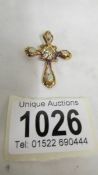 A 14k cross pendant set white stone and four opals, total weight 5.9 grams.