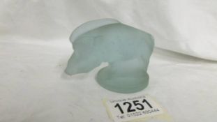 A frosted glass boar paperweight in the style of Lalique.