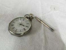 A silver fob watch with key and a silver toothpick.