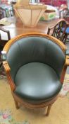 A superb quality leather upholstered revolving bergere chair.