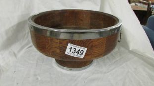 An oak fruit bowl with plated fittings.