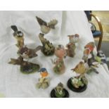 Nine assorted bird figures.